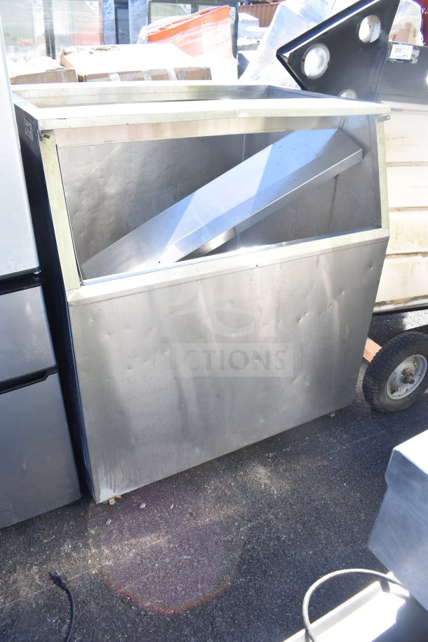 Commercial ice machine bin, stainless steel, showing visible wear and dents. Ideal for large capacity storage in commercial settings.