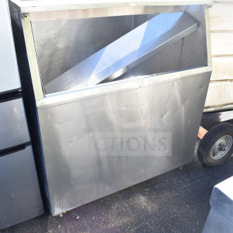 Commercial ice machine bin, stainless steel, showing visible wear and dents. Ideal for large capacity storage in commercial settings.