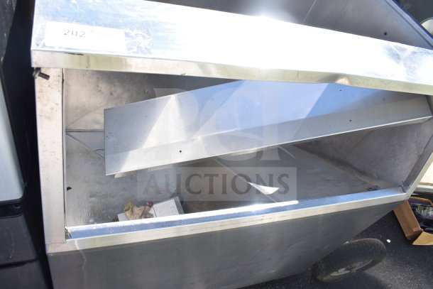 Commercial ice machine bin, stainless steel construction, visible wear and scratches, marking label "202" on top edge.