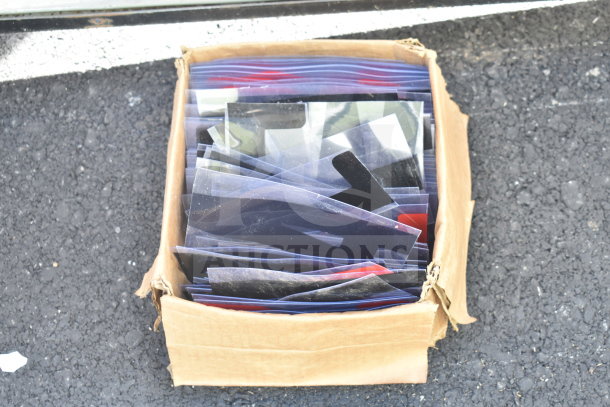 Cardboard box of assorted plastic letters for signage, in used condition.