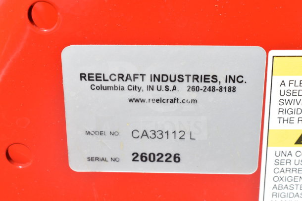 Reelcraft CA33112L hose reel tag showing model CA33112 L and serial 260226, indicating premium-duty make.