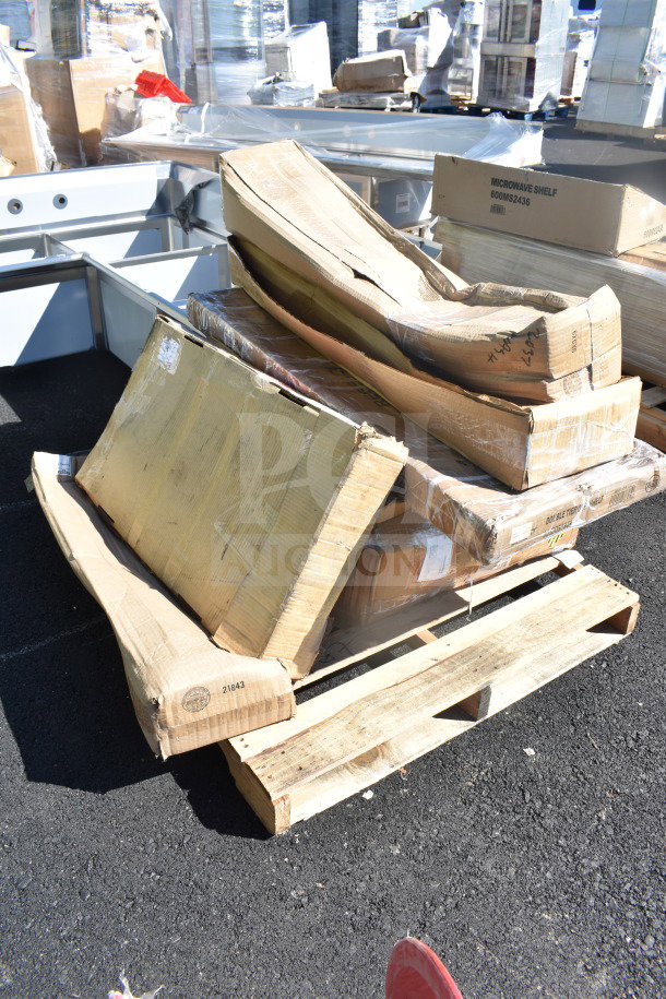 A pallet with boxed, scratch and dent items including Unger OmniClean Dual Bucket Kit and Regency Overshelf, some labels visible.