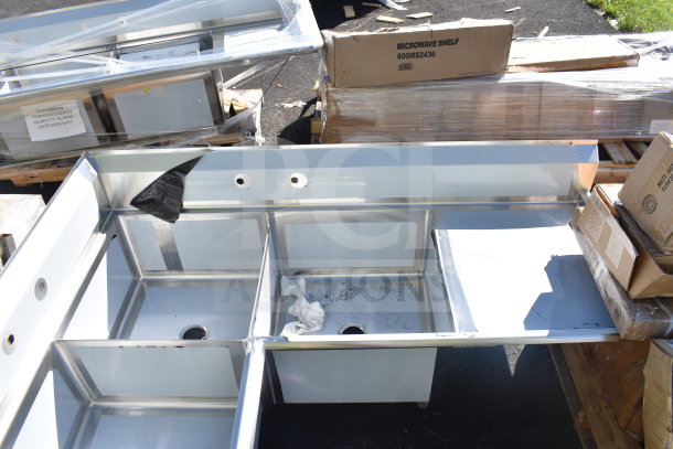 Brand new Regency 600S3242424C 3-bay L-shaped commercial sink, with dual drain boards. Scratch and dent condition. No legs.