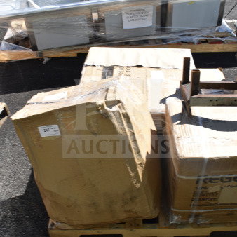 Boxes of scratch and dent items on a pallet, visible labels include Regency and Lancaster, indicating contents include an underbar sink and a live edge table top.