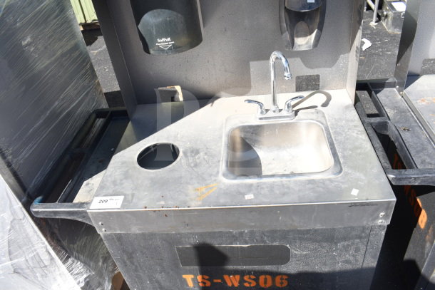 Commercial portable sink with stainless steel basin, faucet, and soap dispenser on commercial casters. Marked TS-WS06. Used condition.
