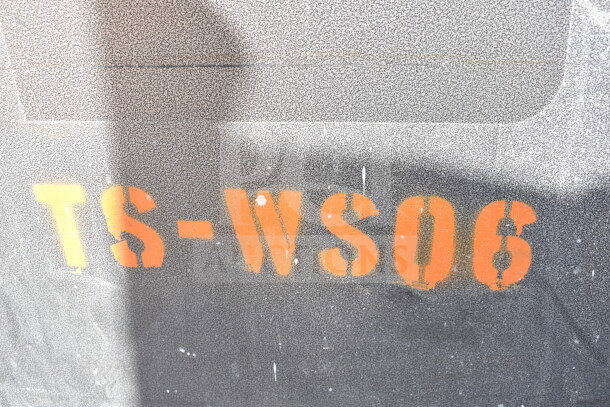 Stenciled marking "TS-WS06" on textured surface of commercial portable sink.