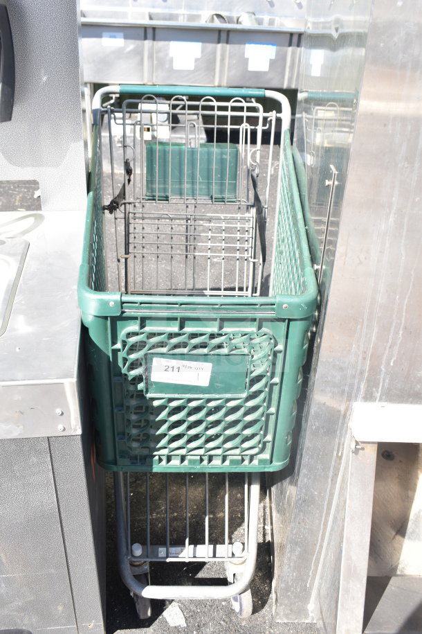 Green shopping cart with metal frame and wire basket, visible wear. Label displaying "211" quantity tag.