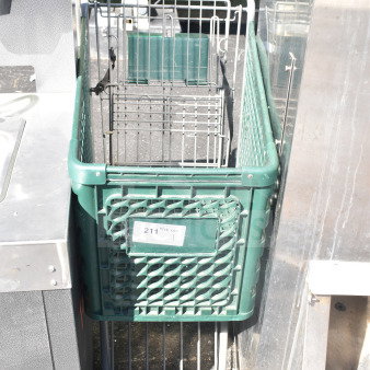 Green shopping cart with metal frame and wire basket, visible wear. Label displaying "211" quantity tag.