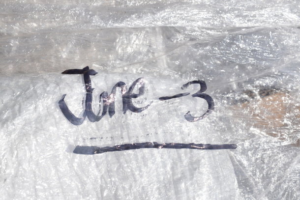 Clear plastic wrap labeled "June-3" covering scratch and dent items including a heating element and stacking kit, brand new.