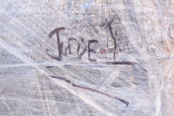 "JUNE-4" handwritten on plastic-wrapped pallet containing 12 new scratch and dent items, including umbrella canopy, wire shelf brackets.