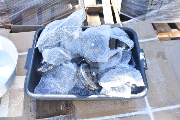Container of bubble-wrapped items, including lids and brackets, suggesting mixed new, scratch-and-dent auction lot.
