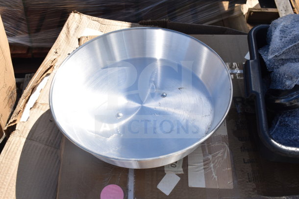 Aluminum wok cover, brand new, on a cardboard box. Minor scratches visible. Part of a scratch and dent auction lot.