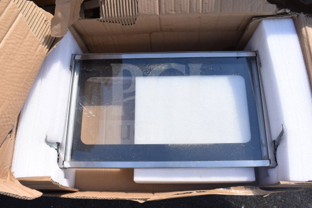 Cardboard box with a glass and metal panel. New, scratch and dent item. Foam padding visible inside box.