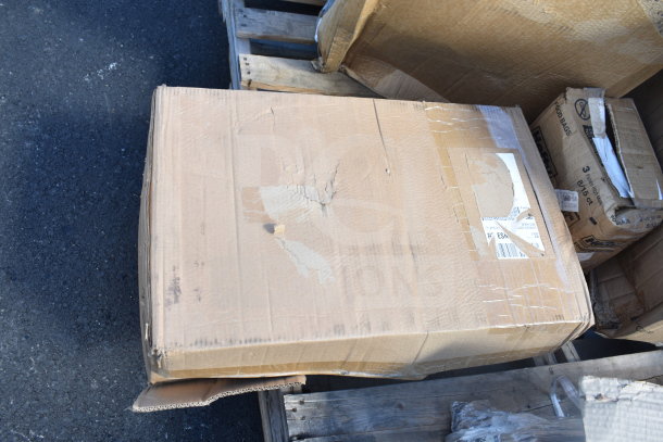 Damaged cardboard box on a wooden pallet, labeled "4 BRAND NEW SCRATCH AND DENT!" with contents including ingredient bins and red chairs.