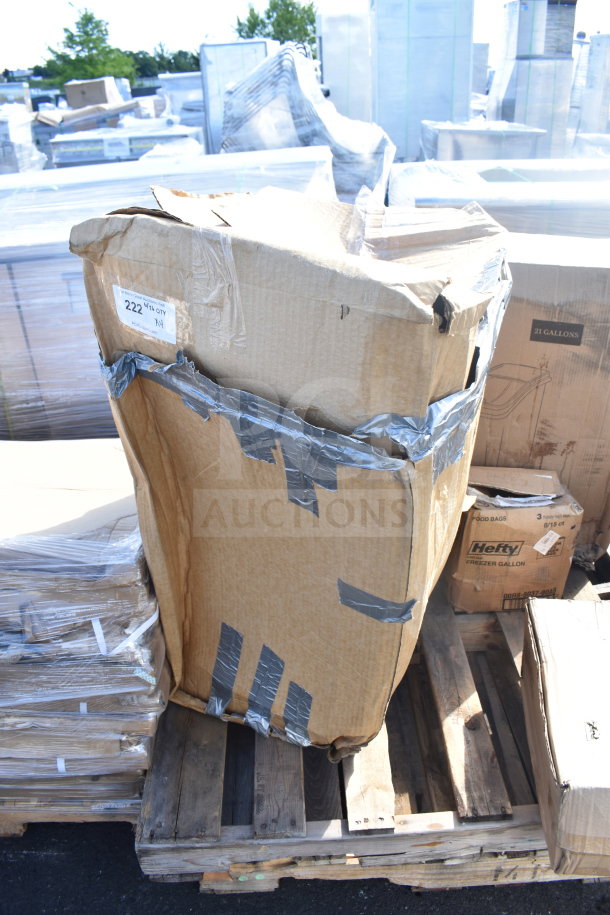 Damaged cardboard box on pallet, marked with “222” and duct-taped. Contains mixed items including ingredient bins and red chairs.