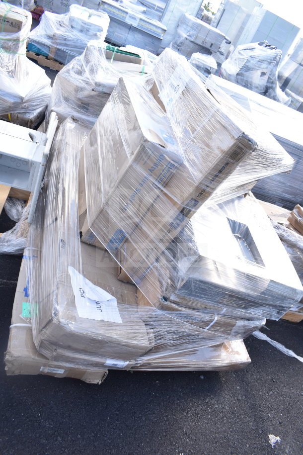 Plastic-wrapped pallet of 12 new scratch and dent items, including shelf kit and cake stand. Boxes labeled with codes JUN26-34, JUN26-55.