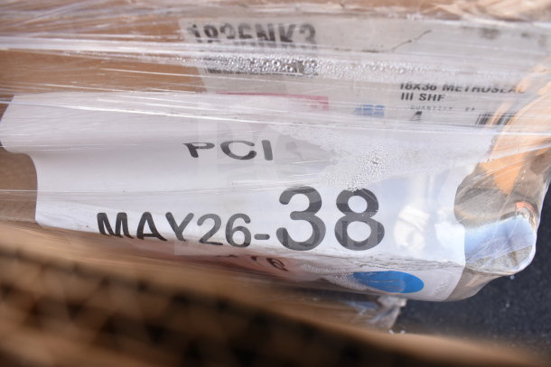 Plastic-wrapped bundle of brand new scratch and dent items with visible label reading "PCI MAY26-38." Marked as 18x36 Metroseal III SHF.