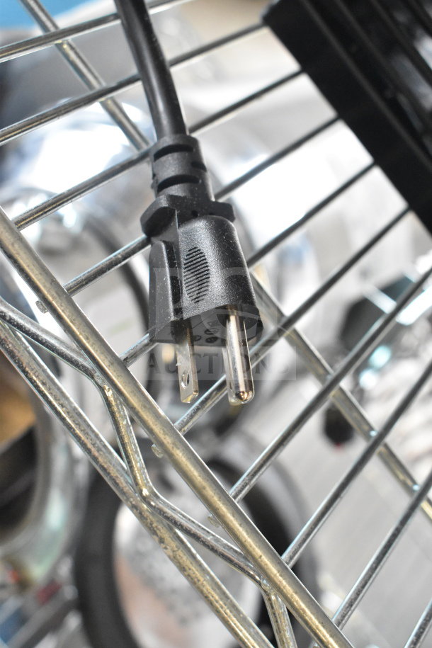 Close-up of a power plug along a metal rack, possibly belonging to the Blendtec ICB5/ABC5 blender.