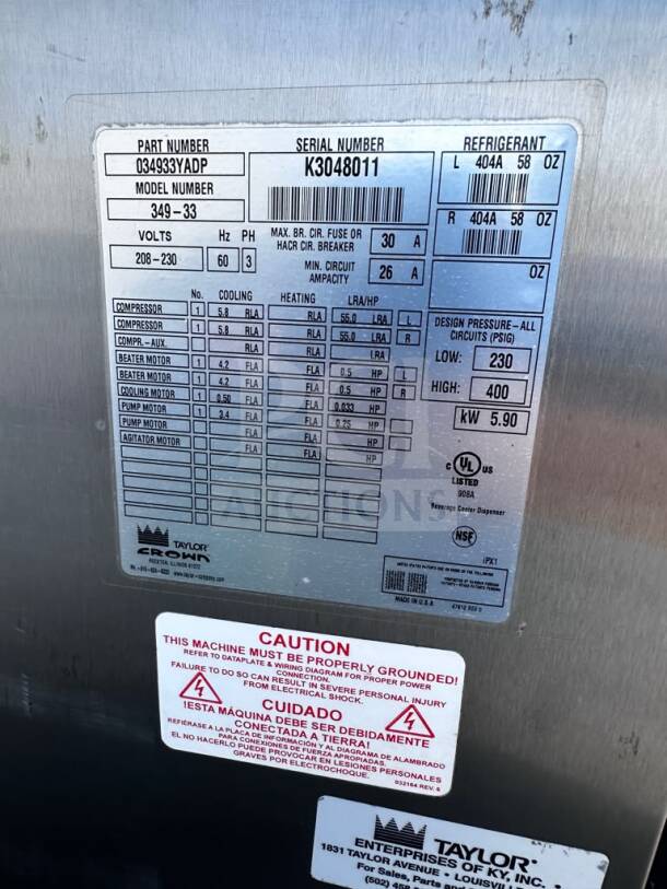 Label on Taylor 349-33 slush machine showing part and serial numbers, voltage, refrigerant type, and safety warnings. UL/NSF listed.