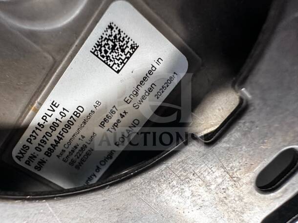 Axis P3715-PLVE camera label showing model 01970-001, IP66/67 rating, origin Poland, and serial B8A4F0907BD.