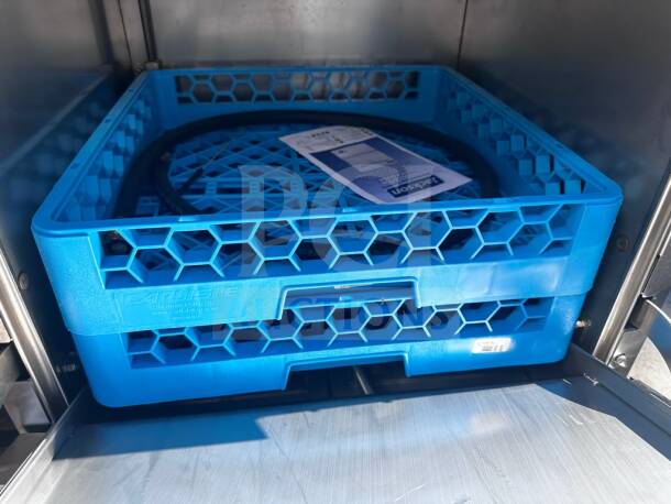 Brand new Jackson DishStar HT-E dishwasher interior with blue Carlisle rack, visible energy-efficient label, ETL/NSF listed.