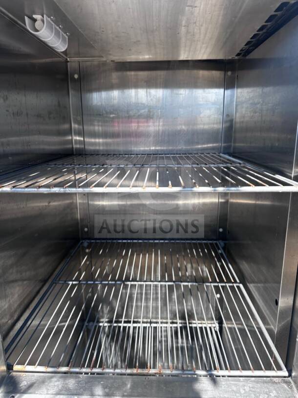 Traulsen RHT132WUT-HHS stainless steel reach-in refrigerator interior, shelves visible, prime condition, UL/NSF listed.