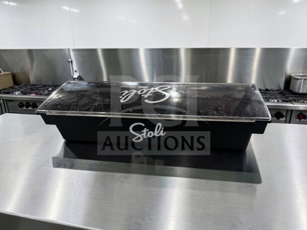 Stoli 6-compartment black plastic condiment caddy with clear lid, in excellent condition, ready for use.