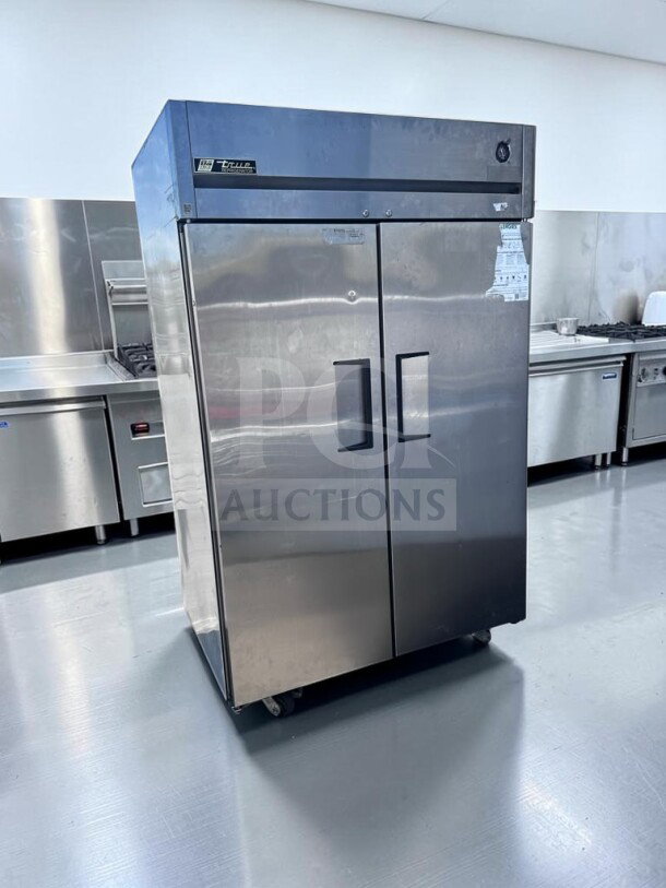 True TG2R-2S two-section stainless steel reach-in refrigerator, 56 Cu. Ft., UL/NSF listed, top-tier condition.