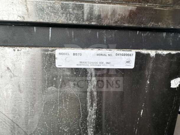 Stainless steel body with visible wear; label reads "Model B570, Serial No. 041020087, Manitowoc Ice, Inc."