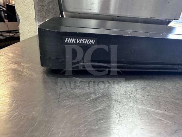 Hikvision DS-7216HQI-K2 DVR, 16-channel, TurboHD, lightly scratched, fully tested, black with logo on front.