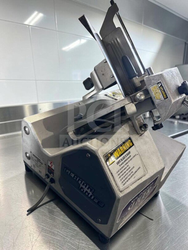German Knife GS-12M 12" manual slicer in top condition, heavy-duty gravity feed design, 1/2 HP, fully tested, operational.