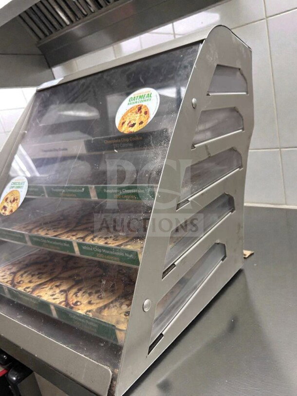 Commercial countertop multi-tier bakery display case with cookies, stainless steel frame, clear panels, excellent condition.
