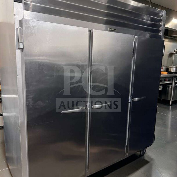 Elite condition Traulsen G31310 reach-in freezer, 77" three-section solid doors, stainless steel, 208/115V, fully operational.
