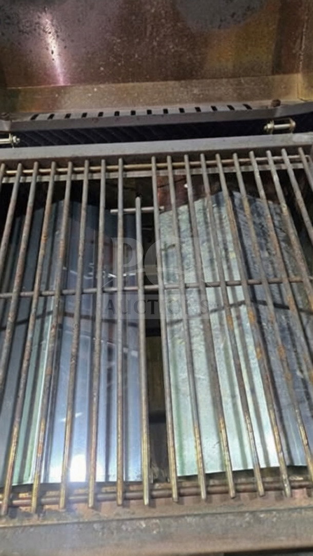 Nexgrill 2-burner stainless steel tabletop grill, model 820-0033, in superior condition. Grates and burners visible.