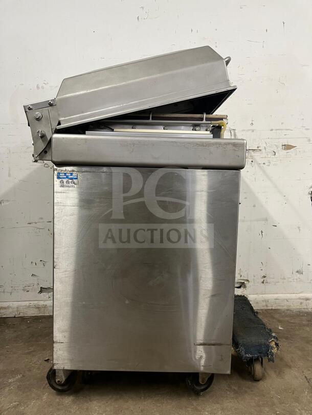 Very good condition Berkel steel vacuum packaging machine, model vacuum machine; features durable stainless steel construction.