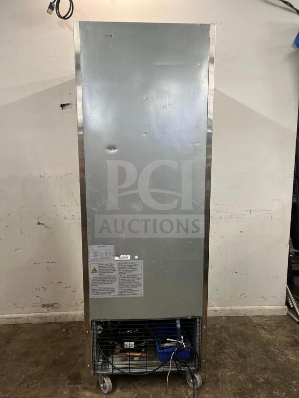 Traulsen G10010 30" reach-in refrigerator, right-hinged, solid door, signs of minor wear, visible labels and safety warnings.