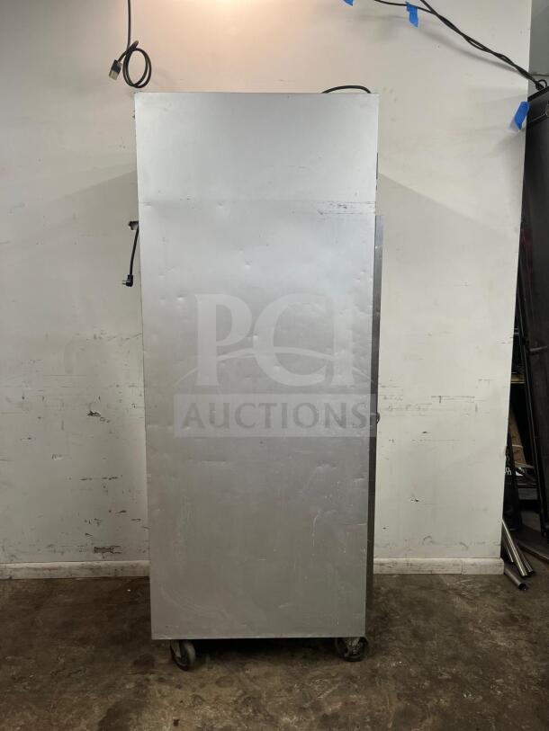 Traulsen G10010 30" G Series solid door reach-in refrigerator, right-hinged, on casters, showing rear view.