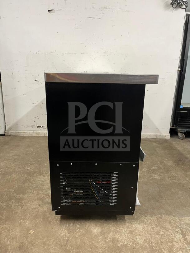 Dukers Back Bar Beverage Cooler DBB72, side view, black finish, visible vent, sturdy stainless steel top, good condition.