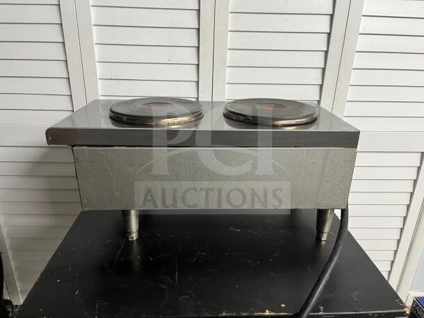 Starmax 602HF Star-Max® 12" electric hot plate with dual burners, metal body, and visible wear marks, on display.