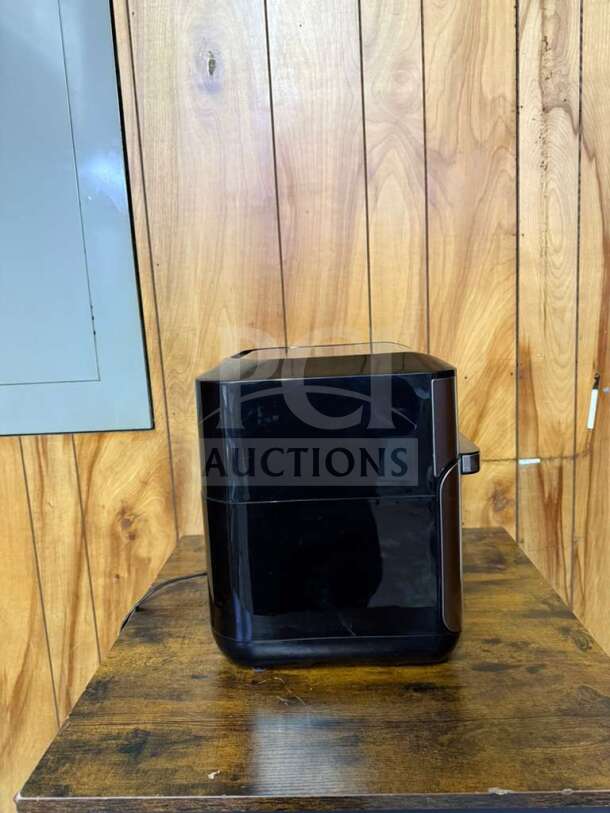 Instant Pot Vortex Plus 10 Quart Air Fryer Oven, black, side view, on wooden countertop, in used condition.