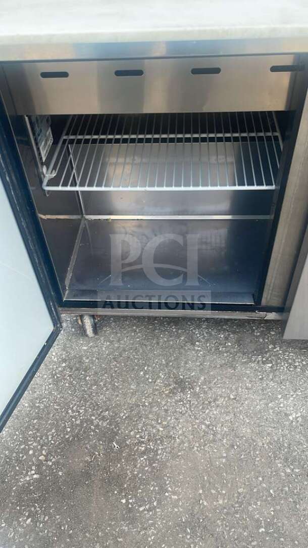Turbo Air MST-72-30-N prep table, stainless steel, 3-door, 72", open door showing interior shelf, good condition.