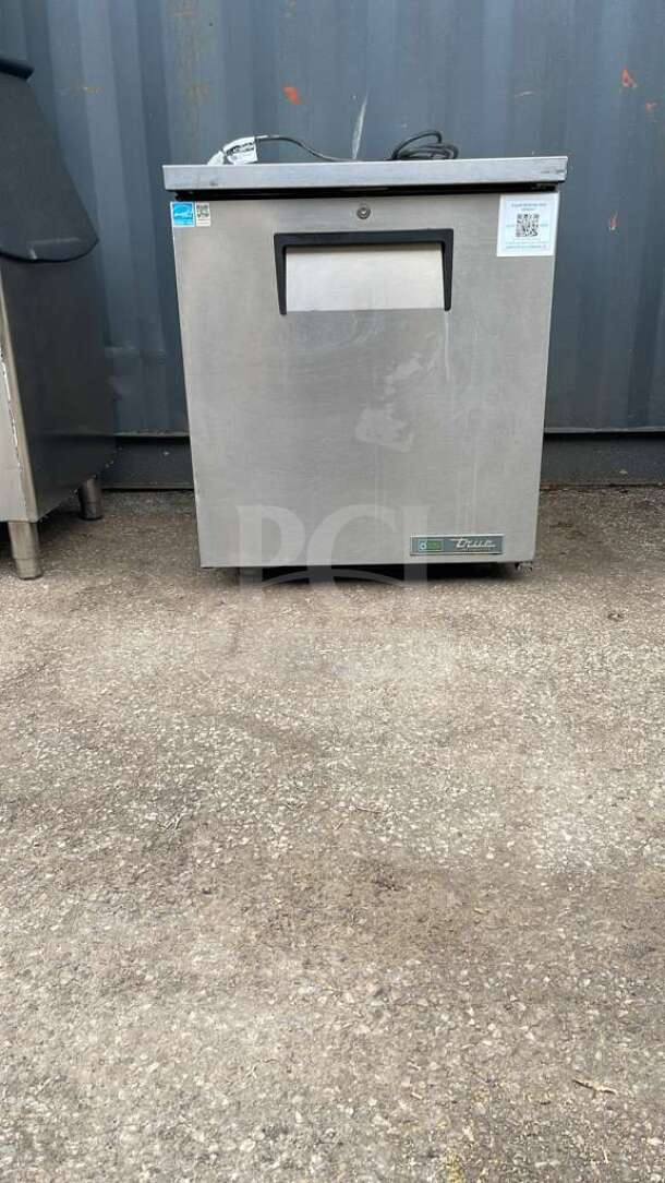 True TUC-27-HC undercounter refrigerator, stainless steel, 27 5/8", model label on front, minor exterior wear.