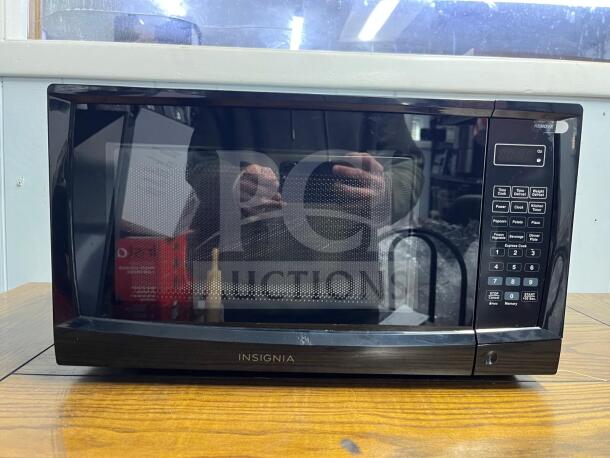 Insignia NS-MW07BKO 0.7 Cu. Ft. compact black countertop microwave, featuring digital controls and multiple preset options.