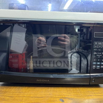 Insignia NS-MW07BKO 0.7 Cu. Ft. compact black countertop microwave, featuring digital controls and multiple preset options.