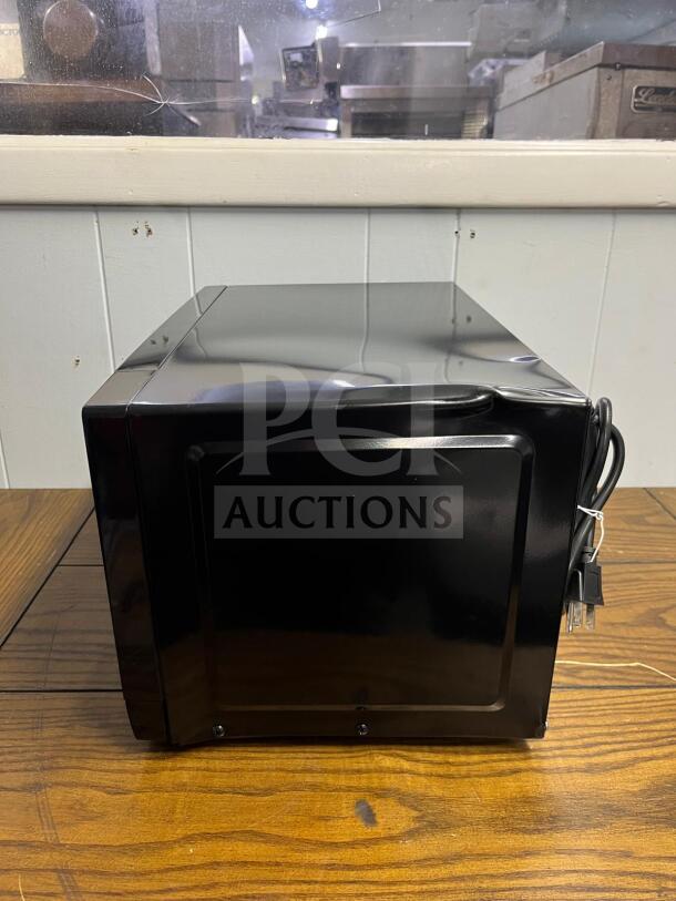 Insignia™ NS-MW07BKO 0.7 Cu. Ft. Compact Countertop Microwave in black, excellent condition, side view.