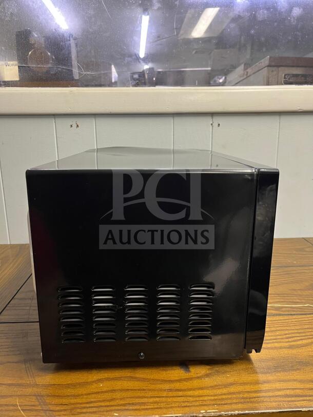 Insignia NS-MW07BKO 0.7 Cu. Ft. Compact Microwave, black, side view, excellent condition, vent detailing visible.