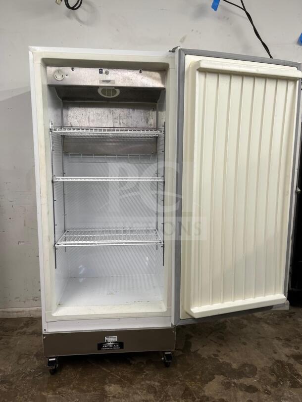 Arctic Air F22CWF 22 Cu.Ft commercial freezer, solid door, NSF certified, white interior, visible shelving, good used condition.