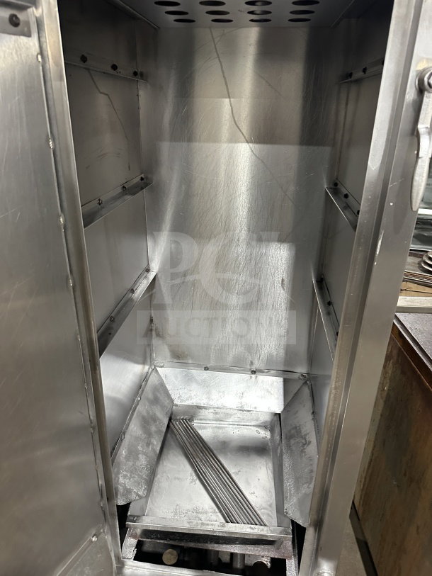 Commercial stainless steel smoker oven with galvanized interior, mounted on legs. Excellent condition for professional use.