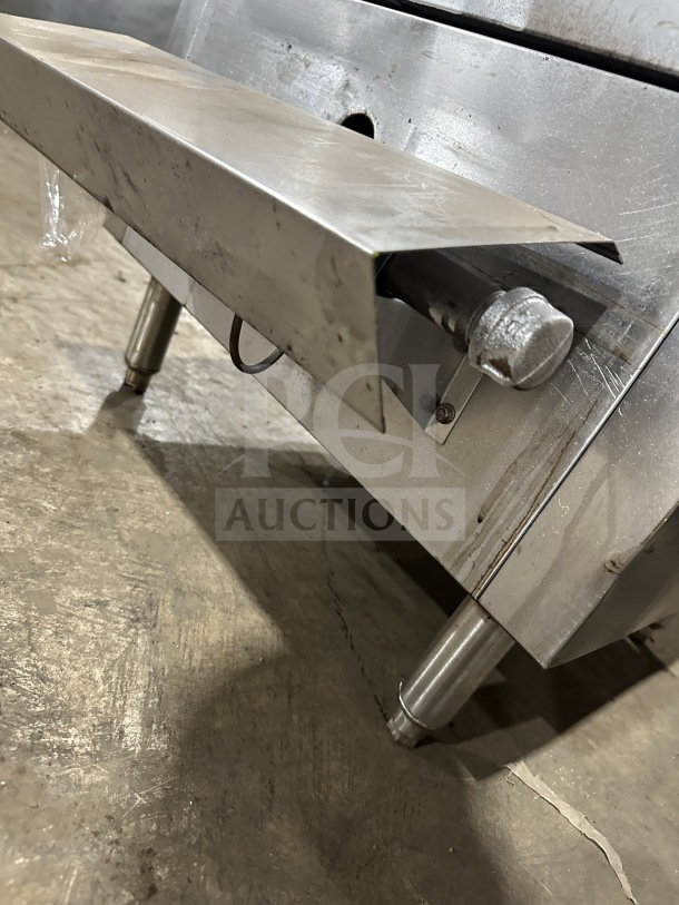 Commercial stainless steel smoker oven with galvanized interior, shown on sturdy metal legs. Visible wear indicates prior use.