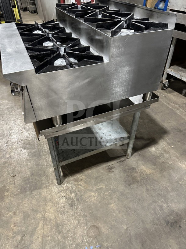 UltraMax 6-burner stainless steel gas hot plate range on open equipment stand. Commercial-grade with slight wear.